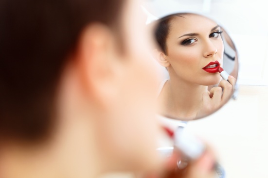 Close up Portrait of Young Woman With Red Lips. Beautiful Woman Doing Daily Makeup. Lipstick applying